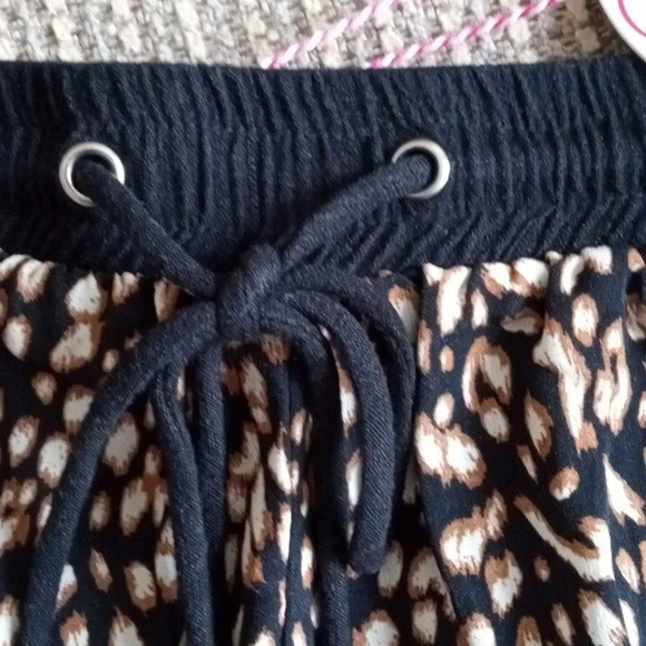 Umgee medium animal print front, solid black cheeky shorts with fringed hem. NWT - Picture 2 of 7